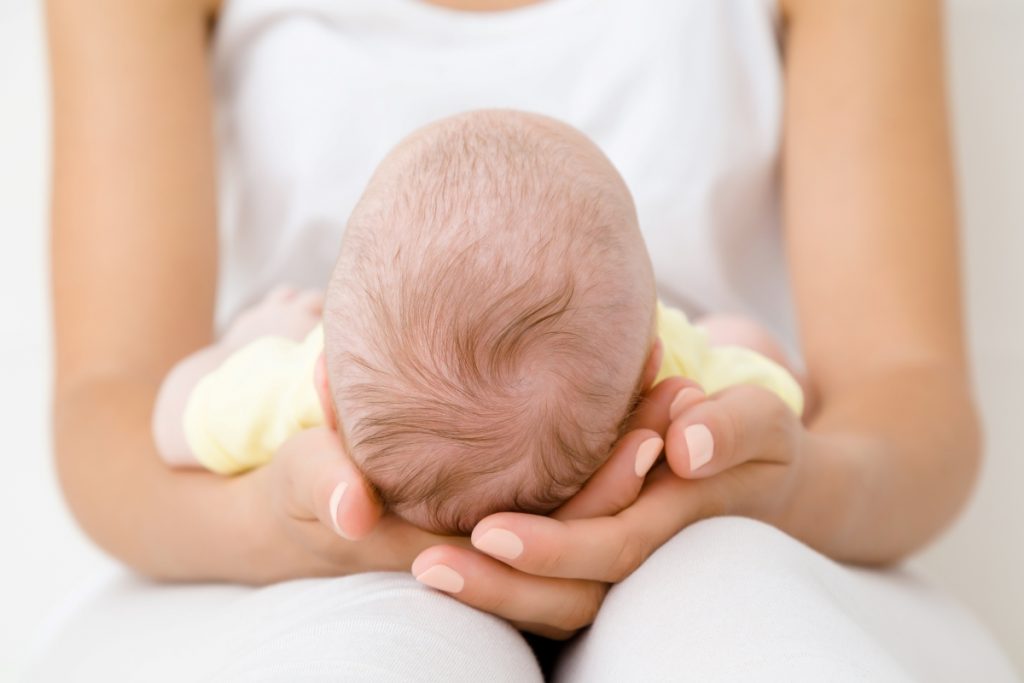 Mom doing gentle yoga; healing after birth